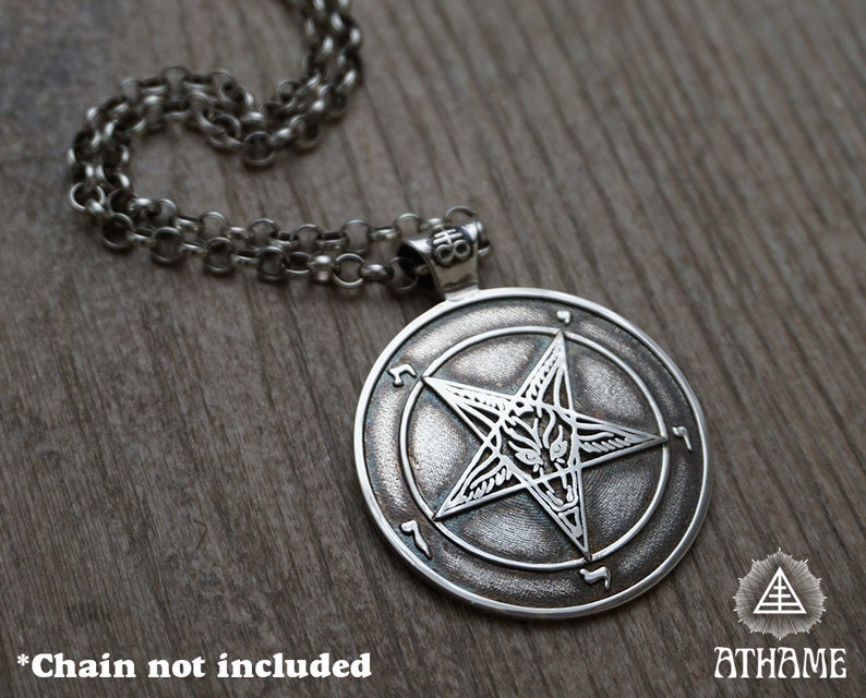 May include: Silver pendant necklace featuring a pentagram with a goat's head inside, surrounded by a circle of Hebrew characters. The pendant is on a silver chain. *Chain not included*