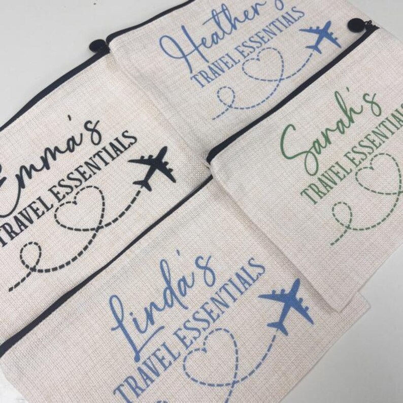 May include: Four personalized travel pouches with black, green, and blue accents. Each pouch features a name, the words "Travel Essentials", a heart with a dotted line, and an airplane.
