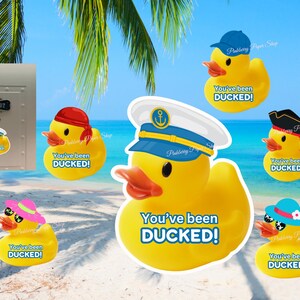 May include: A collection of yellow rubber duck stickers, each wearing a different hat, including a sailor cap, pirate hat, and baseball cap. The text "You've been DUCKED!" is on each duck. A mailbox with a duck sticker is also visible.