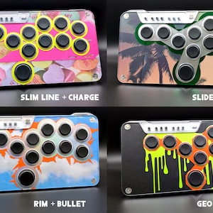 May include: Four arcade fight sticks with different designs. One has a pink background with candy hearts, another has a palm tree design, a third has a sky and cloud design, and the last has a black background with neon green drips. Each stick has black buttons and text.