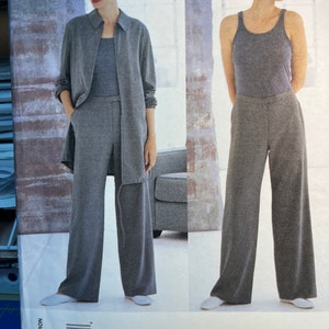 May include: A sewing pattern for a pair of wide-leg pants and a long-sleeved shirt. The pattern is by Calvin Klein, Vogue American Designer, and is size 12-14-16.