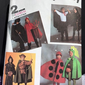 May include: Simplicity sewing pattern number 470, featuring 2-hour express collection costumes for children. The pattern includes a devil, a ladybug, a green dragon, a Robin Hood, and a vampire costume.