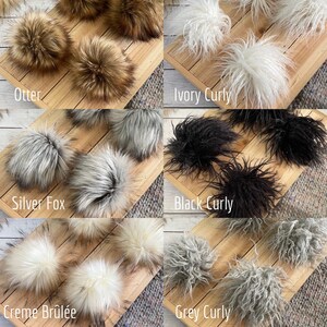 May include: Assortment of faux fur pom poms in various colors and textures, including otter, silver fox, creme brulee, ivory curly, black curly, and grey curly.