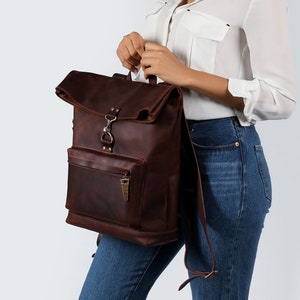 Experience the essence of craftsmanship with the Forester, a handcrafted leather backpack designed for both practicality and style. This unique design backpack is distinguished by its roll-top closure and front zipper pocket for easy access.