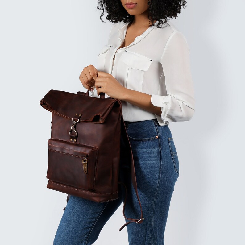 Experience the essence of craftsmanship with the Forester, a handcrafted leather backpack designed for both practicality and style. This unique design backpack is distinguished by its roll-top closure and front zipper pocket for easy access.