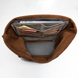 Inside, it boasts a padded laptop compartment that fits laptops up to 16 inches, alongside larger and smaller organizer pockets and three card holders, ensuring everything has its place.