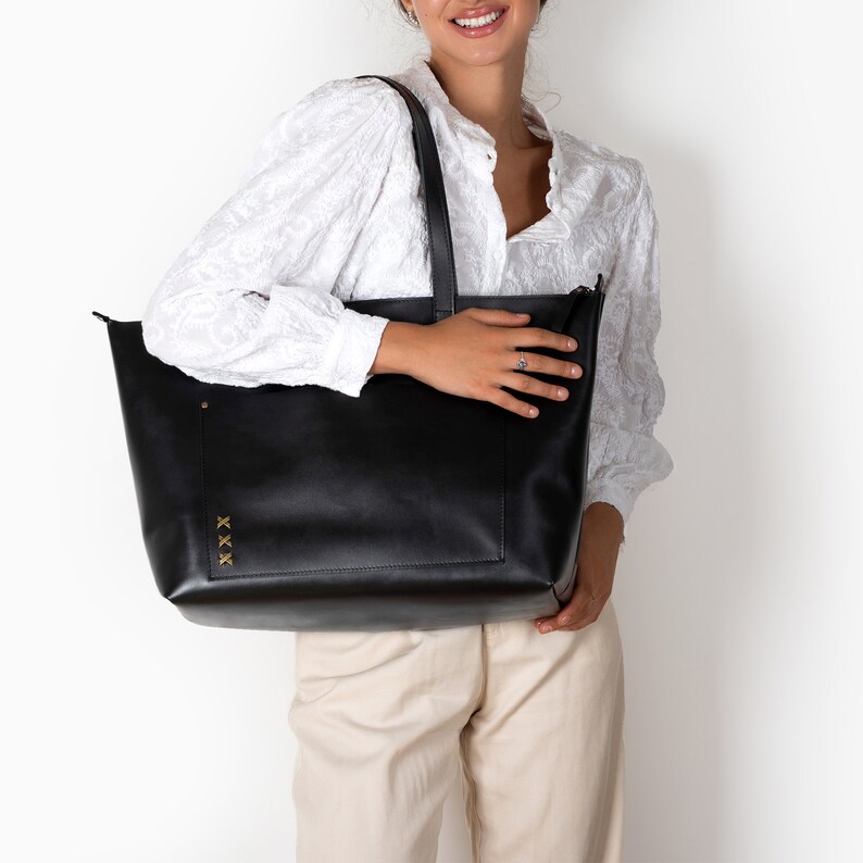 A large leather bag can be a sports bag under your uniform, a bag for diapers and baby stuff, a weekender travel bag.