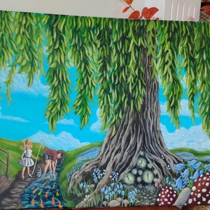 May include: A colourful painting shows a weeping willow tree with green foliage. Two children are fishing in a stream with orange fish. The scene includes bluebells, toadstools, and a fairy-tale tree entrance, set against a bright blue sky.