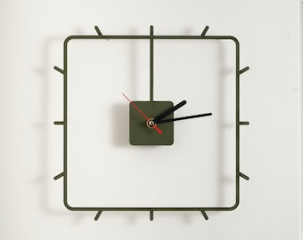 Simple, filigree and timeless wall clock made of thin wood lasered for your office, living room or kitchen. Square design.