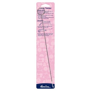 May include: A pink and white packaging card with instructions for using a loop turner tool. The tool is a long, thin, silver needle with a loop at one end. The text on the card reads "Loop Turner".
