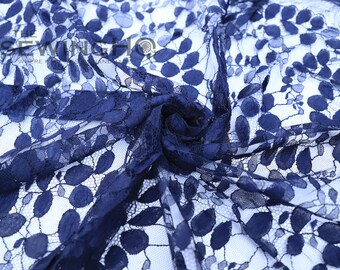 May include: Navy blue lace fabric with a delicate floral pattern. The lace is sheer and has a soft, flowing texture.