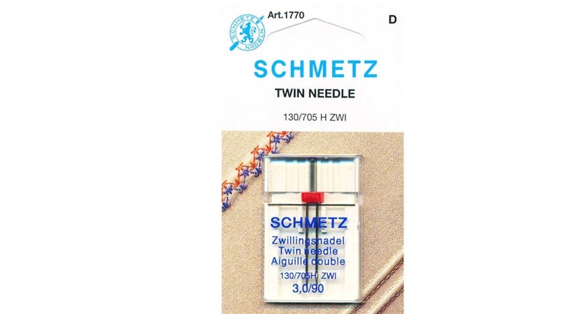 May include: A package of Schmetz twin needles, size 130/705 H ZWI, 3.0/90. The package is white with blue and red accents. The needles are in a clear plastic case.