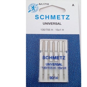 May include: A package of five silver sewing machine needles, labeled "SCHMETZ UNIVERSAL 130/705 H - 15x1 H 90/14".