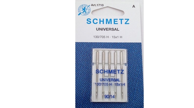 May include: A package of five silver sewing machine needles, labeled "SCHMETZ UNIVERSAL 130/705 H - 15x1 H 90/14".
