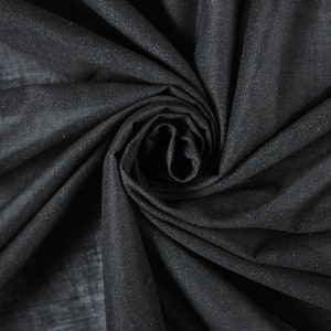 May include: Black fabric with a subtle sparkle, draped and folded into a swirl.