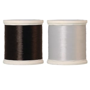May include: Two spools of thread, one black and one silver, on white spools.