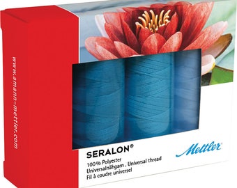 May include: Two spools of blue Seralon thread, a 100% polyester universal thread. The packaging features a water lily flower and the Mettler brand name.