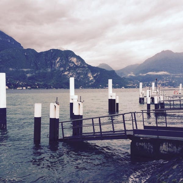 Dock and pylons on Lake Como, Bellagio, Lombardy, Italy. Looming clouds over the Italian lake and mountains. Digital Download. Travel photo