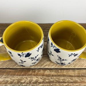 Set of 2 Anthropologie LOREN 12 oz Mugs, White with Blue Floral Motif, Yellow Inside, Geometric Handle, Butterfly Stamp image 2