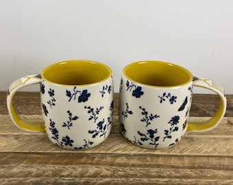 Set of 2 Anthropologie LOREN 12 oz Mugs, White with Blue Floral Motif, Yellow Inside, Geometric Handle, Butterfly Stamp