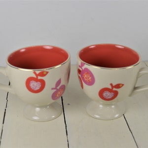 Set of 2 Anthropologie Fruit 8 oz Pedestal Cups, Ivory with Gold Trim, Bright Coral Pink Apples Purple Red, Black Bird Logo