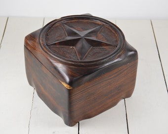 May include: A dark brown wooden box with a carved five-pointed star on the lid.