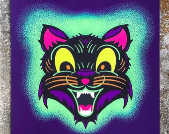 May include: A black cat with a wide grin and yellow eyes, printed on a purple background with a green and blue spray paint effect.