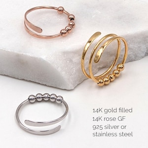 May include: Three rings in gold, rose gold, and silver. Each ring features a band with small, round beads. The gold ring has a double band design. The text in the image reads: "14K gold filled, 14K rose GF, 925 silver or stainless steel."