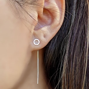 Op de afbeelding: Zilveren cirkelvormige oorbellen met een 40 mm ketting die eronder hangt. STYLE C staat onder de afbeelding.