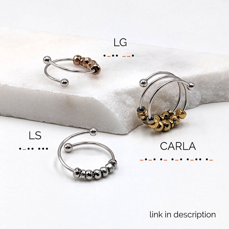 May include: Three silver hoop earrings with a row of silver beads. The earrings are labeled "LG", "LS", and "CARLA".