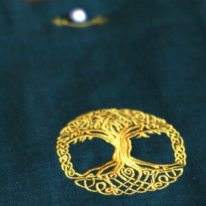 May include: A green fabric pouch with a gold embroidered Celtic knot tree of life design.