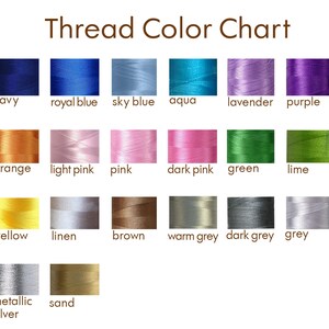May include: Thread color chart with 24 different colors of thread spools. The colors include white, navy, royal blue, sky blue, aqua, lavender, purple, cranberry, red, orange, light pink, pink, dark pink, green, lime, avocado, gold, yellow, linen, brown, warm grey, dark grey, grey, dove grey, metallic gold, metallic silver, sand, and black.