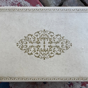 60s 70s VINTAGE jewelry box beige cream vegan leather ornate acanthus gold trim red satin lining rectangle mid-century Hollywood Regency