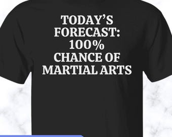 May include: A black short-sleeved t-shirt featuring white text that reads: TODAY'S FORECAST: 100% CHANCE OF MARTIAL ARTS. The shirt has a crew neckline and a standard fit, with the graphic centered on the chest area in a bold, sans-serif font.