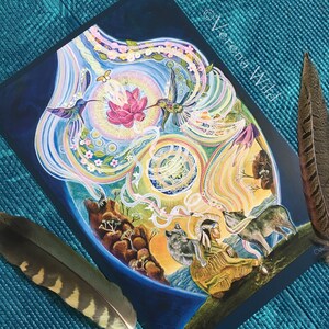 May include: An art print featuring a vibrant, dreamlike illustration with hummingbirds, a lotus flower, and wolves. The artwork includes the text "Verena Wild" and is accented by two feathers.