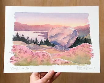 May include: Watercolor painting of a landscape featuring a large boulder, pink and purple hills, and a lake under a sunset sky. The artwork is signed and titled "Cloughmore Stone".