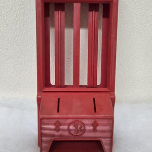 May include: Red plastic Chiclets gumball dispenser with a slot for coins and a clear plastic window to view the gumballs. The dispenser has a sign that reads "Chiclets".