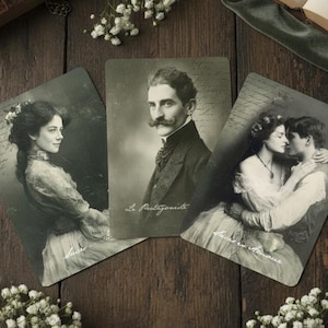 May include: Three rectangular cards featuring sepia-toned vintage portraits. The left card shows a woman, the center card depicts a man with a mustache labeled Le Protagoniste, and the right card shows a couple embracing labeled Les Amoureux.