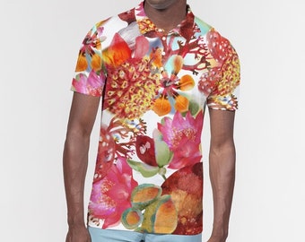 May include: A white polo shirt with a colorful floral print. The flowers are red, orange, yellow, pink, and green. The shirt has a collar and short sleeves.