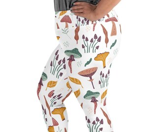 May include: White leggings with a colorful mushroom pattern. The mushrooms are in shades of brown, green, and purple.