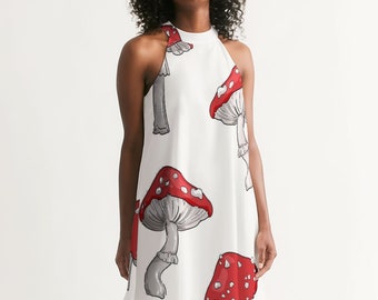 May include: A white halter dress with a red and white mushroom print. The dress has a loose fit and a flowy skirt.