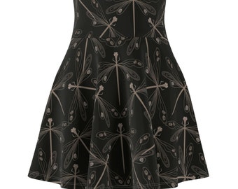 May include: Black skater skirt featuring a repeating pattern of tan dragonfly illustrations. The skirt has a high waist and a flared silhouette, suitable for various occasions. The fabric appears to be a soft, flowing material.