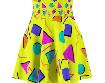 May include: A bright yellow skater skirt with a vibrant 80s-inspired geometric pattern. The design features purple squares, pink triangles, teal circles, and orange zigzags. The skirt has a high waist and a flared silhouette.