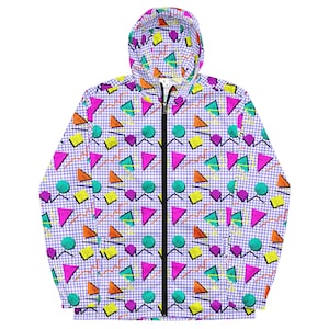 May include: A white hooded jacket with a geometric pattern in shades of pink, blue, yellow, green, and orange. The pattern includes circles, triangles, and squares on a grid background.