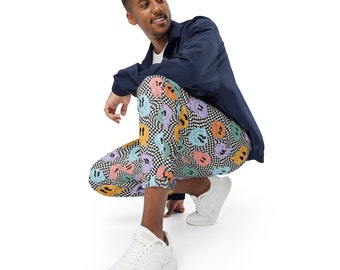 May include: A person wearing a navy blue jacket and black and white checkered pants with a colorful smiley face pattern. The person is sitting with their legs crossed and wearing white sneakers.