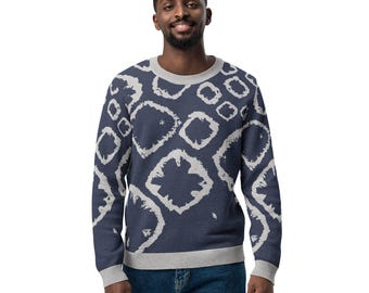 May include: A navy blue sweater with a white geometric pattern. The sweater has a crew neck and long sleeves.