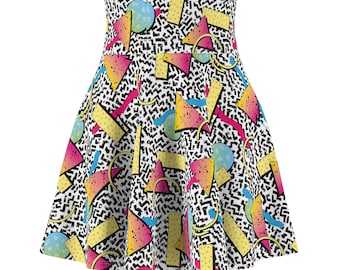 May include: A white skater skirt with a geometric print featuring bright colors like pink, yellow, blue, and orange. The print includes various shapes like triangles, circles, and rectangles.