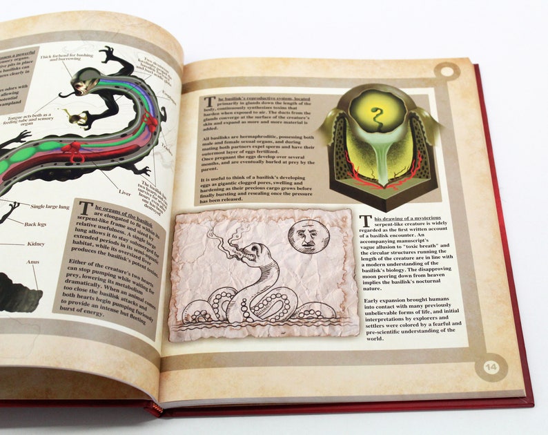 May include: An open book with illustrations of a basilisk, a mythical creature. The left page features a diagram of the basilisk's anatomy, while the right page shows a drawing of the creature and text. The book has a red cover.