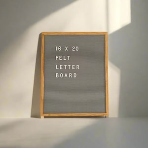 May include: A grey felt letter board with a wooden frame. The board is 40.6 cm by 50.8 cm and says "16 x 20 FELT LETTER BOARD".