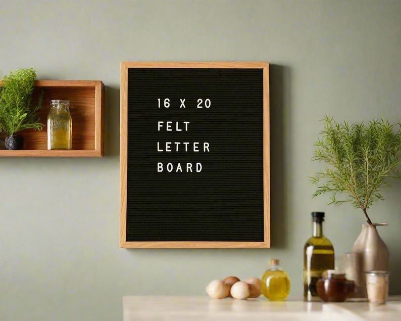 May include: A black felt letter board with a wooden frame. The board has the text "16 x 20 Felt Letter Board" written on it.